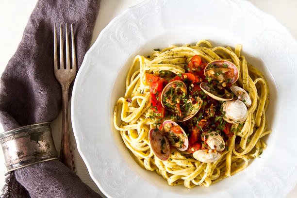 istock Italian tagliatelle in a restaurant with mussels and tomatoes. Dark background. 843590270