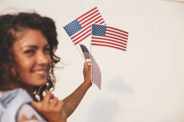 istock Smiling girl showing american flags 843590404