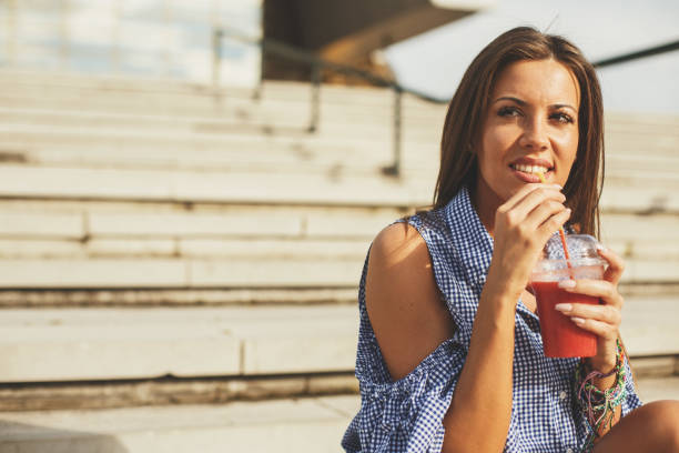 istock Young woman posing with a fruit smoothie 843590854