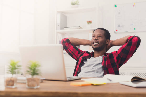 istock Young relaxed businessman with laptop in modern white office 843591376