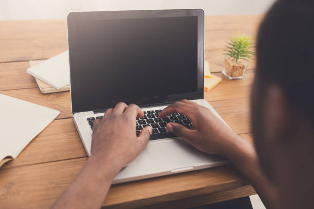 istock African-american businessman in office type on laptop 843593636