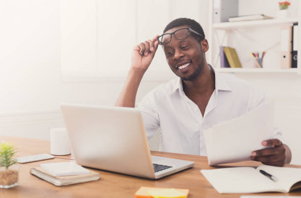 istock Black businessman in office, work with laptop and documents 843593742