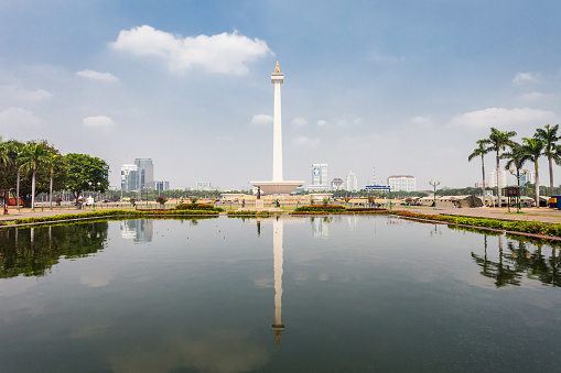 JAKARTA, INDONESIA - OCTOBER 21, 2014: The National Monument is a 132m tower in the centre of Merdeka Square, Jakarta, symbolizing the fight 