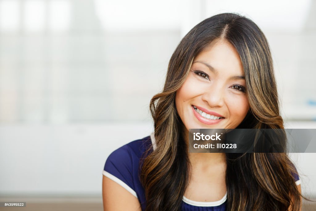 Close-up of a pretty Asian woman smiling in the city Pretty Asian woman smiling in the city Women Stock Photo