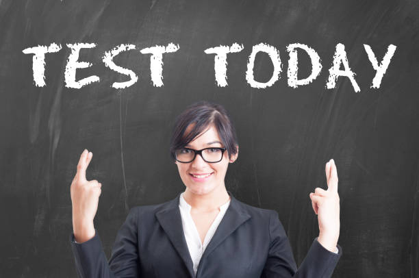 istock Beautiful woman teacher giving test to student 843607132