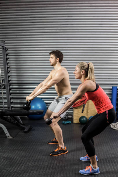 istock Couple lifting dumbbells together 843607182