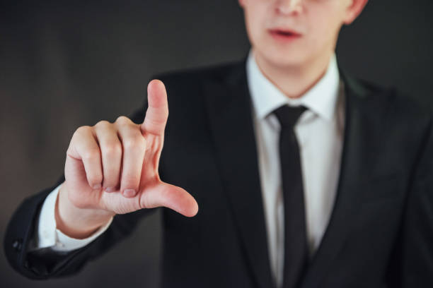 istock Businessman hand pointing on empty space on black background 843607458