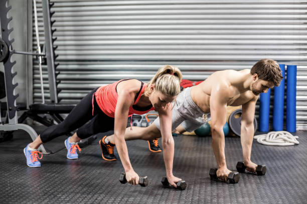 istock Couple doing push up with dumbbells 843607558
