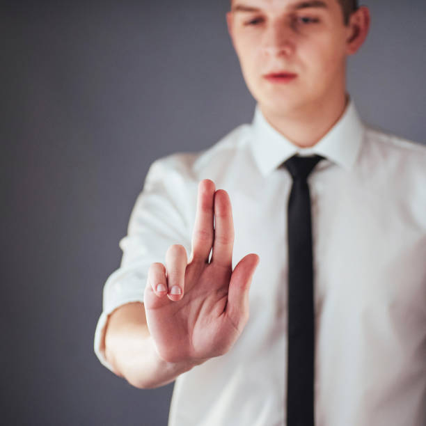 istock Businessman hand pointing on empty space on black background 843607968