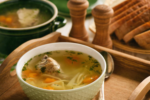istock Chicken soup in bowl on wooden tray. 843608288