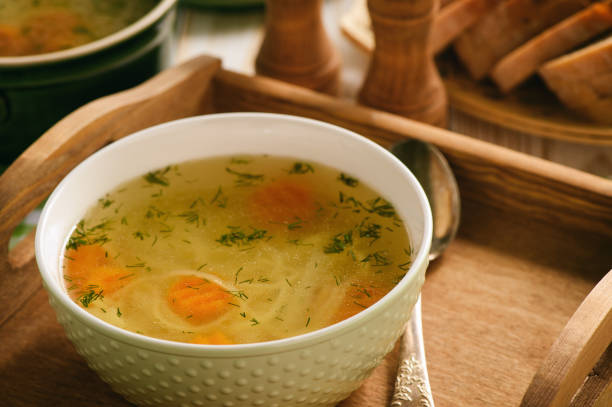 istock Chicken soup in bowl on wooden tray. 843608292