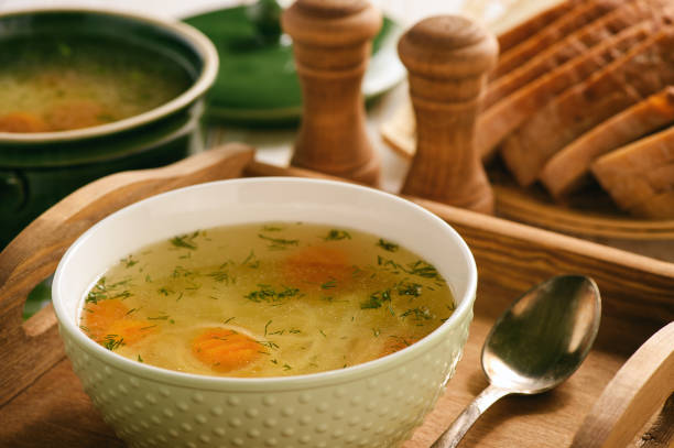 istock Chicken soup in bowl on wooden tray. 843608300