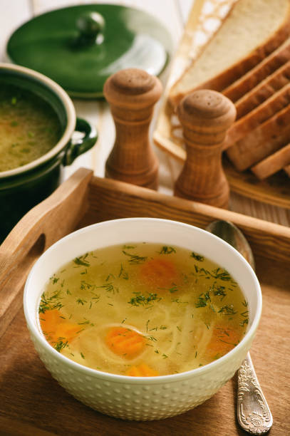 istock Chicken soup in bowl on wooden tray. 843608306
