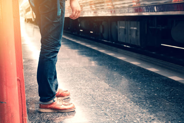istock Young traveler asian man standing on platform waiting in train. 843611466
