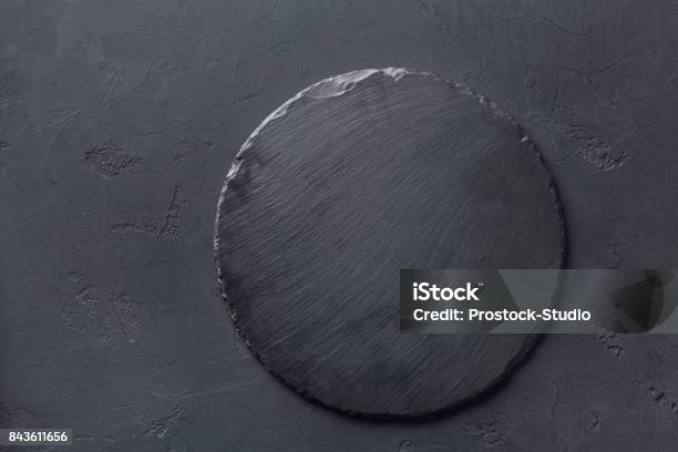 Empty Rustic Black Slate Stone Plate On Dark Background Stock Photo - Download Image Now