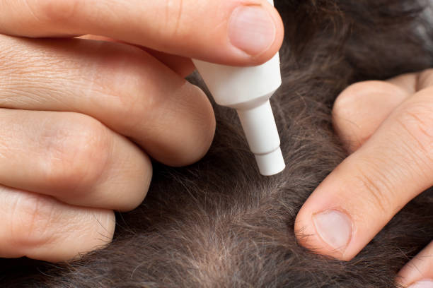 istock hand with dog remedy from fleas and ticks 843612194