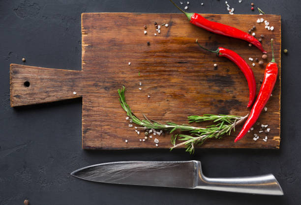 istock Wooden desk with spices and chilli on dark background 843612614
