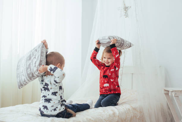 istock Child in soft warm pajama playing in bed 843617202