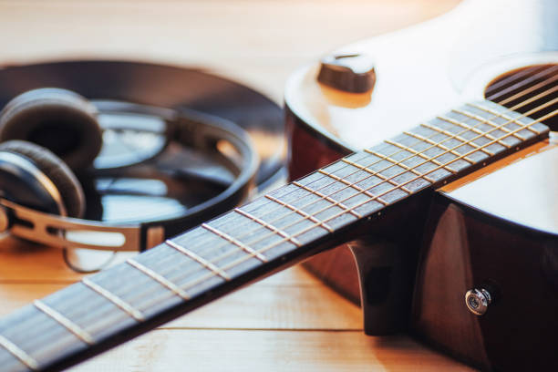 istock Classical guitar with headphones on a wooden background 843617672