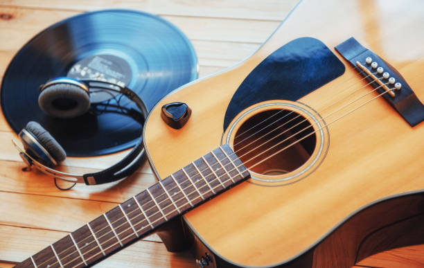 istock Classical guitar with headphones on a wooden background 843617810