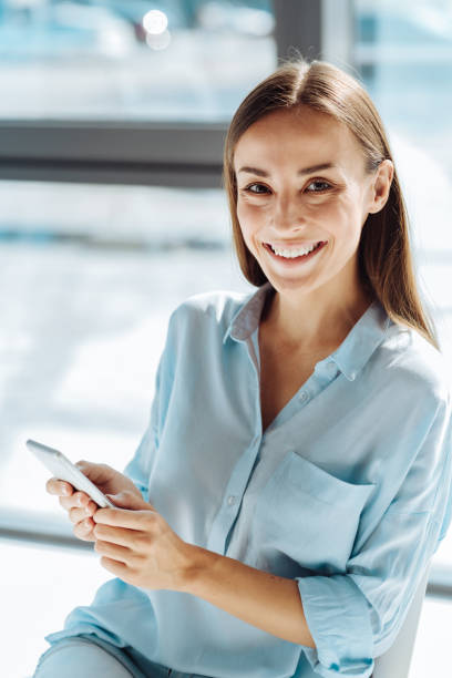 istock Positive young woman using her smart phone 843618372