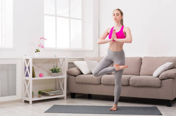istock Woman training yoga in tree pose. 843622626