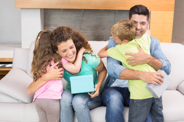istock Young siblings giving presents to their parents 843622882