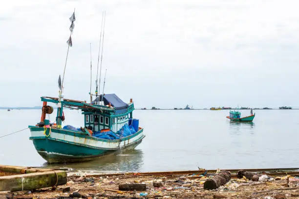 SIHANOUKVILLE, CAMBODIA - 7/20/2015: Two fishing boats along the coast of Cambodia.
