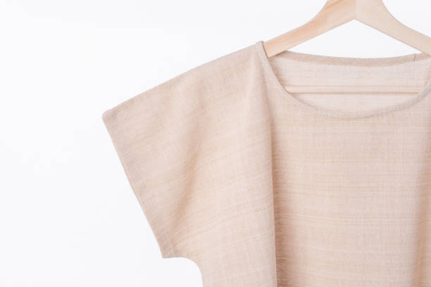 istock cotton beige plain woman blouse on white background. 843629240
