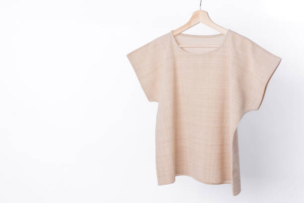 istock cotton beige plain woman blouse on white background. 843629296