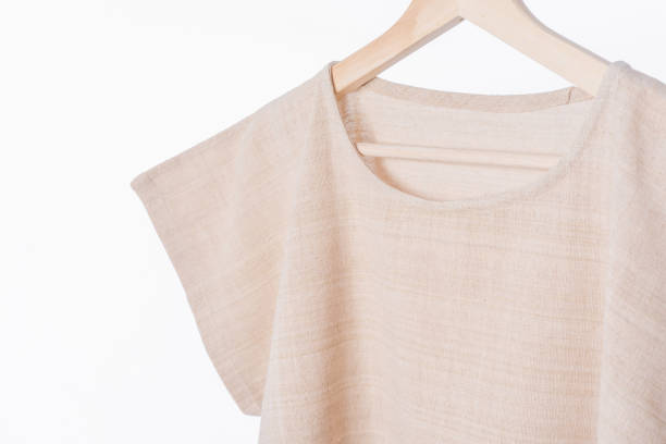 istock cotton beige plain woman blouse on white background. 843629556