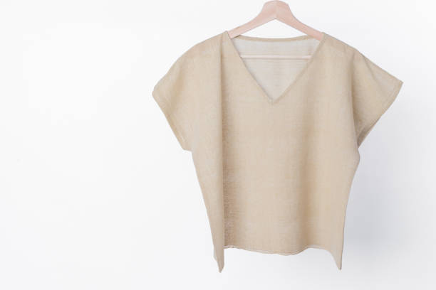 istock cotton beige plain woman blouse on white background. 843629592