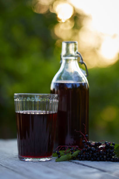istock Glass of fresh elderberry syrup and elderberries 843630490
