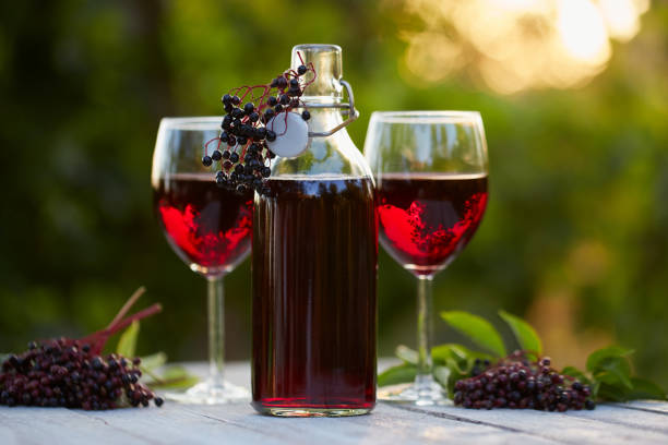 istock Bottle and glasses of elderberry wine 843630546