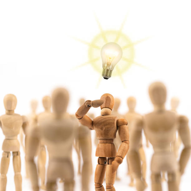 istock Wooden mannequin has a new idea in the crowd 843630840