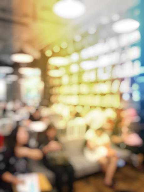 istock Blurred image of people sitting in cafe reading books and  using computers, smartphone.Education concept 843634216