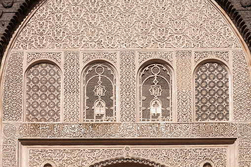 MARRAKESH, MOROCCO - FEBRUARY 22, 2016: Pattern design element on Ben Youssef Medersa, it is an Islamic college in Marrakesh, Morocco.