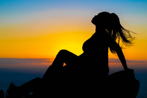 istock Profile silhouette of a woman on a rock 2 843641714