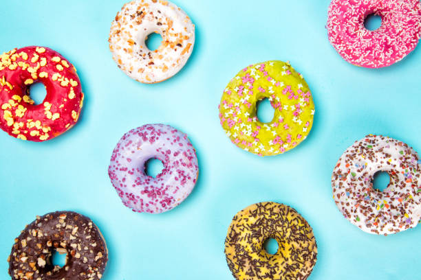 istock Donuts glazed with sprinkles on pastel blue background 843642666