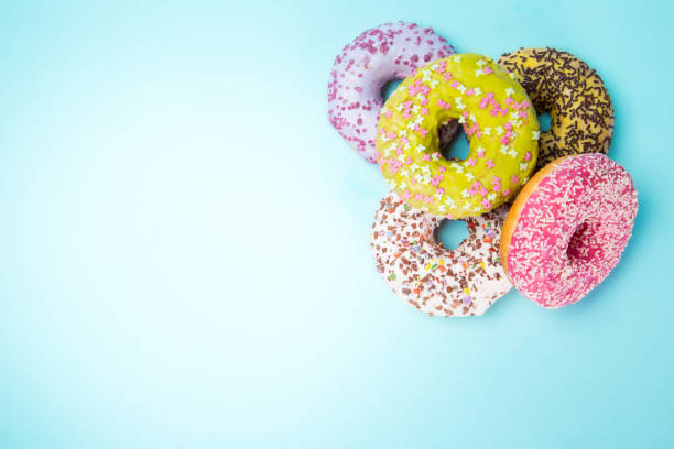 istock Donuts glazed with sprinkles on pastel blue background 843642920