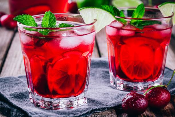 istock ice refreshing cherry lemonade in glass with ice cubes, lime and mint 843643594