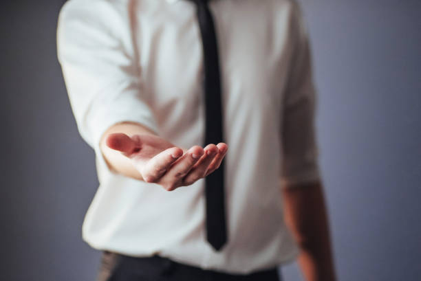 istock Young businessman showing empty hands, ready to fill with your design 843643598