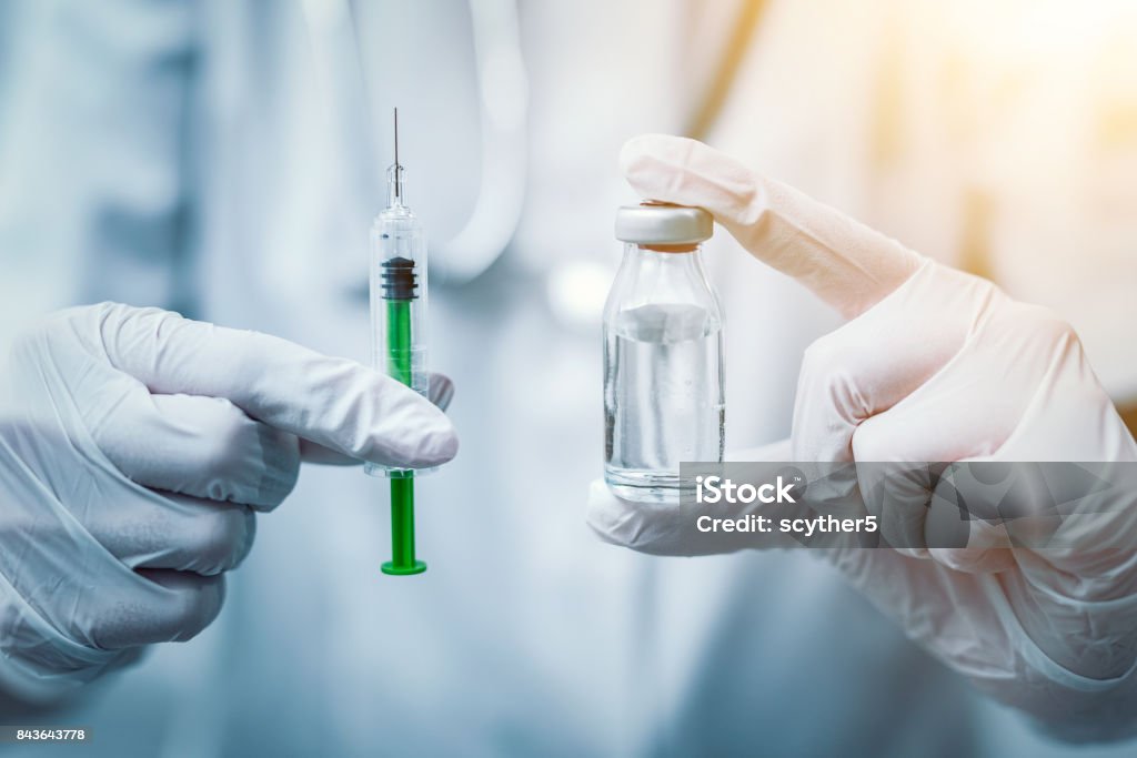 Syringe, medical injection in hand. Vaccination equipment. Syringe, medical injection in hand. Vaccination equipment with needle. Vaccination Stock Photo