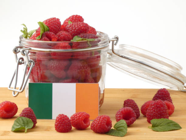istock Irish flag on a wooden panel with raspberries isolated on a white background 843653112