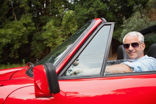 istock Cheerful handsome man enjoying his red convertible 843653250