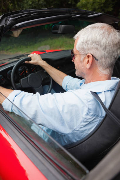 istock Handsome man driving his red convertible 843653286