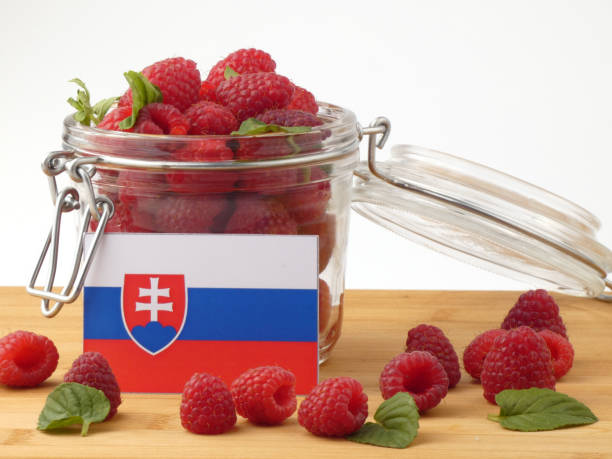 istock Slovakian flag on a wooden panel with raspberries isolated on a white background 843653430