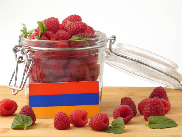 istock Armenian flag on a wooden panel with raspberries isolated on a white background 843653442