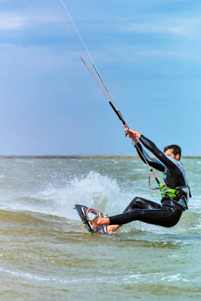 istock Man riding a kite surfing on the waves in the summer. 843653454