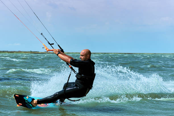 istock Man riding a kite surfing on the waves in the summer. 843653478